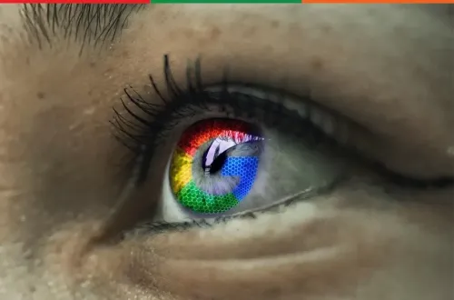 A close-up of an eye with the Google colours reflected in it