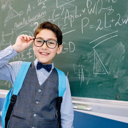 Child with glasses reviewing our question and answers