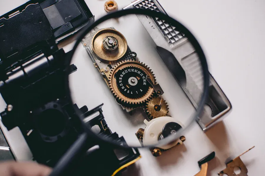 A magnifying glass over the gears inside a camera
